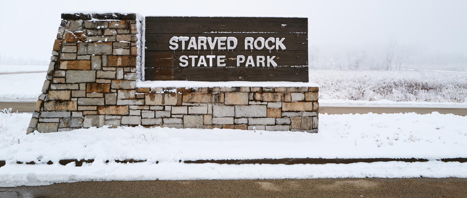 A photo featuring the sign for Starved Rock State Park.