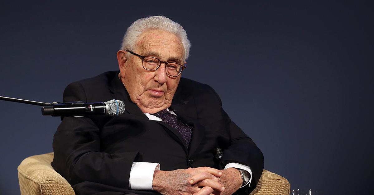 Henry Kissinger sitting with a mic next to him during an event for Angela Merkel on Jan. 21, 2020