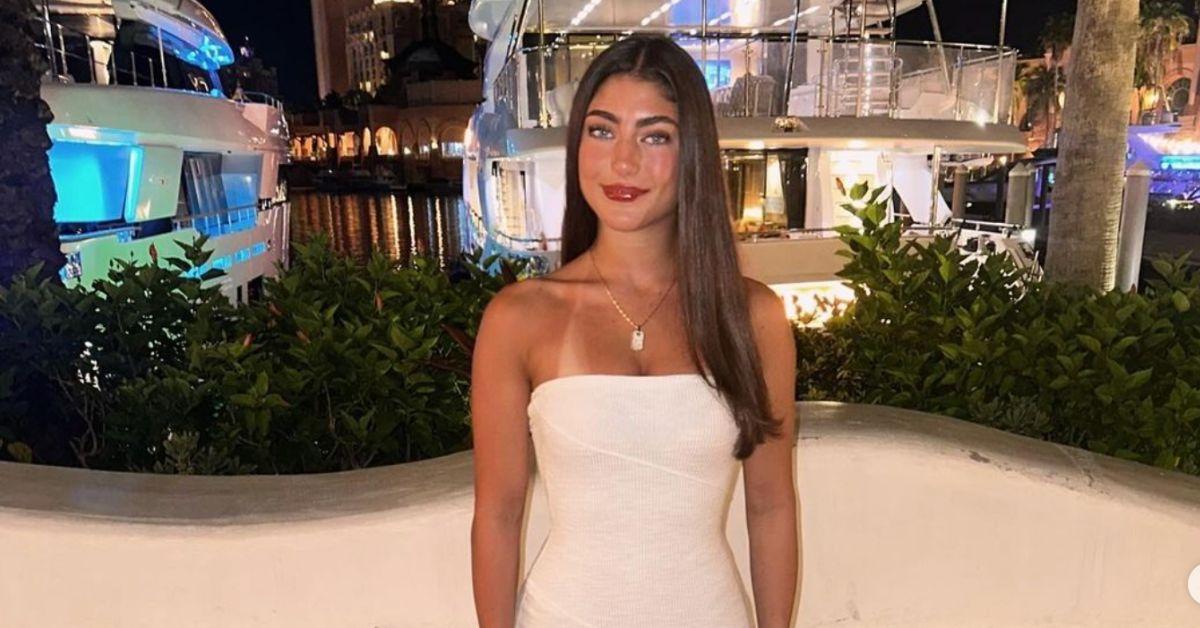 Audriana Giudice posing for a photo in front of a yacht harbor.