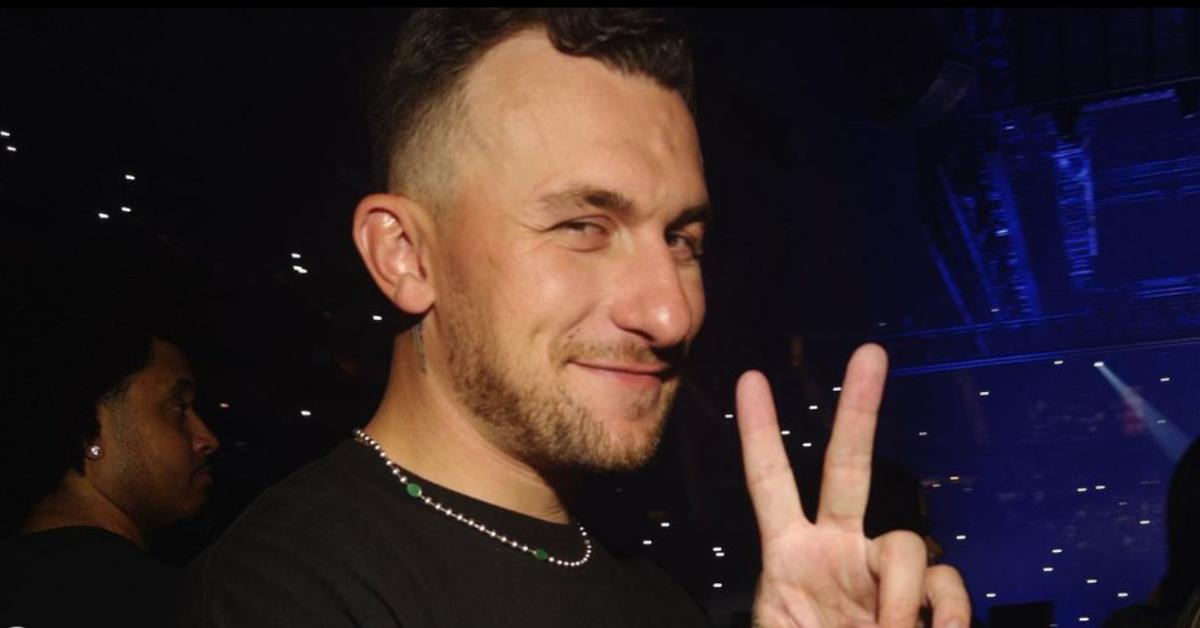 Johnny Manziel holding up the peace sign at a concert.