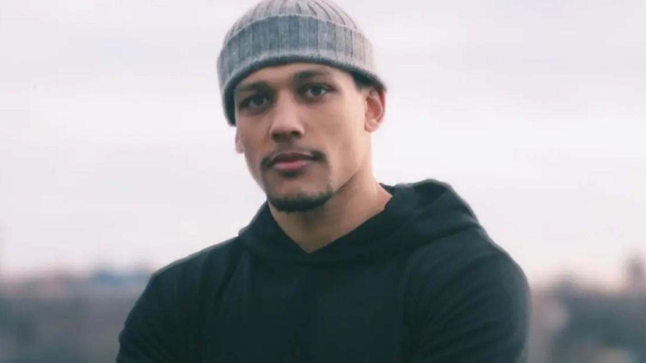Josh Popper from 'Summer House' wearing a black hoodie and gray beanie