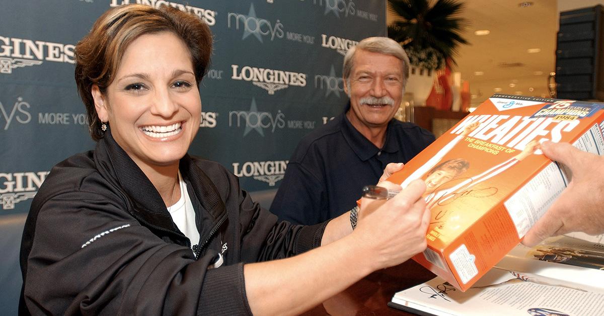 Mary Lou Retton signing a box of Wheaties.