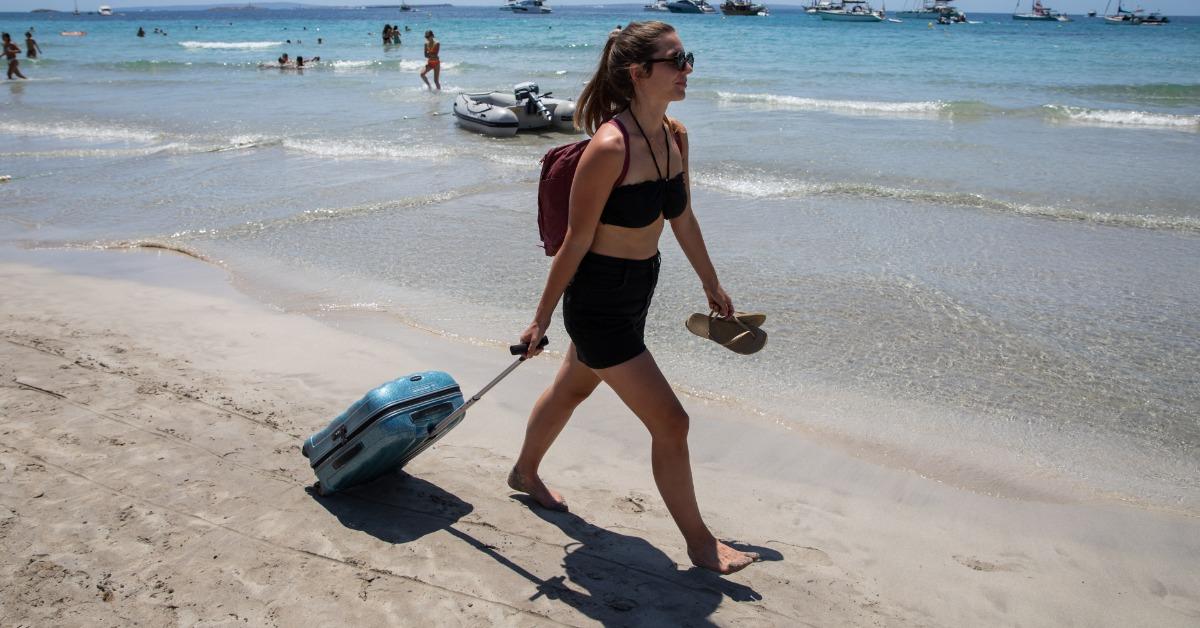 A person walking a suitcase