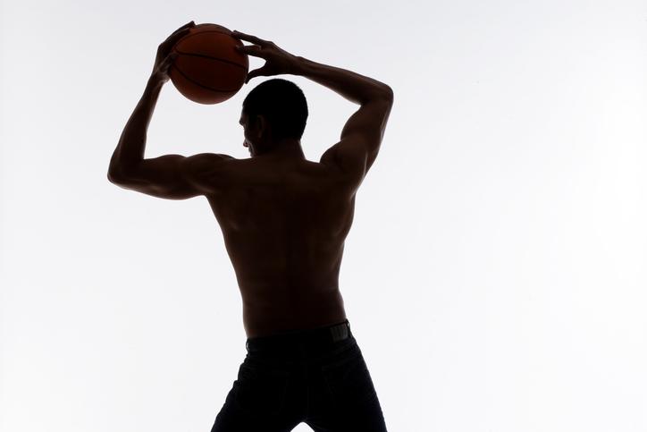 Silhouette of a man holding a basketball 