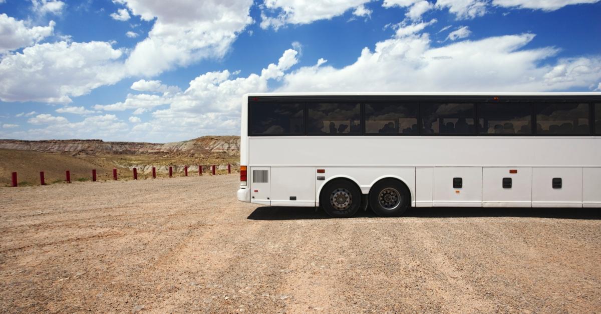 Tour bus parked in dirt lot