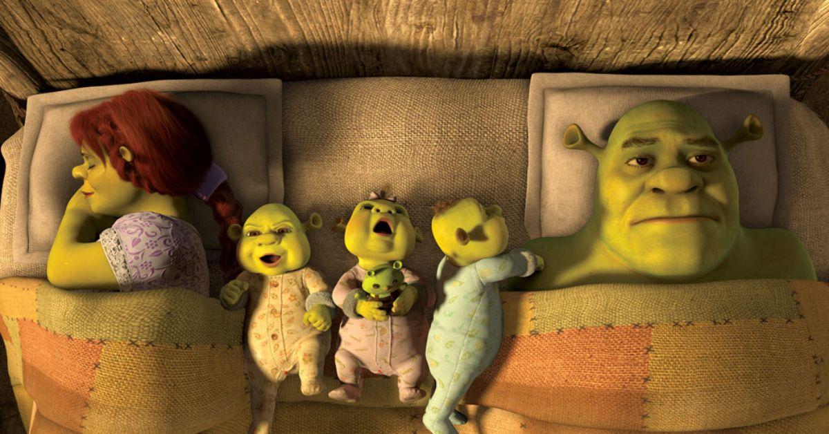 Shrek, Fiona and their three children in bed. 