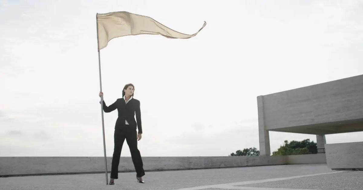 A woman holding a beige flag.