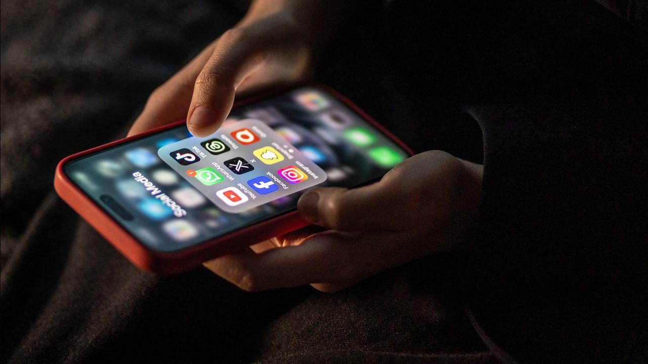 A person looking at social media apps, including Instagram, on their smartphone