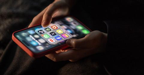 A person looking at social media apps, including Instagram, on their smartphone