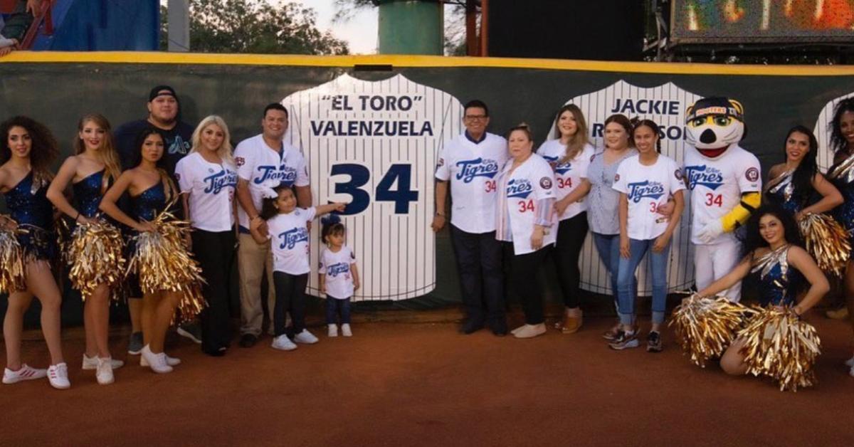 Fernando Valenzuela standing next to his retired jersey in 2019.