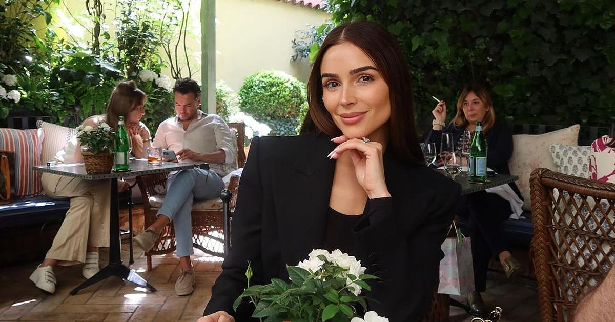 Photo of model and actress Olivia Culpo wearing a black blazer at an outdoor eatery