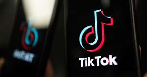 A person showing the TikTok logo on their phone