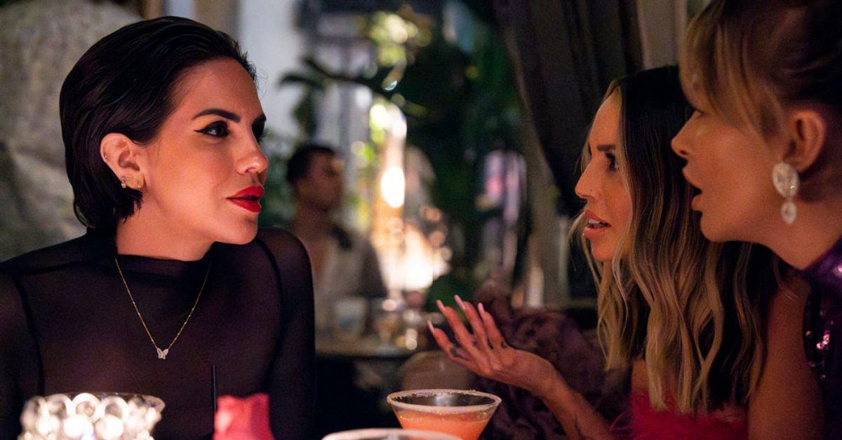 Katie Maloney sits across from Scheana Shay and Lala Kent in a restaurant 