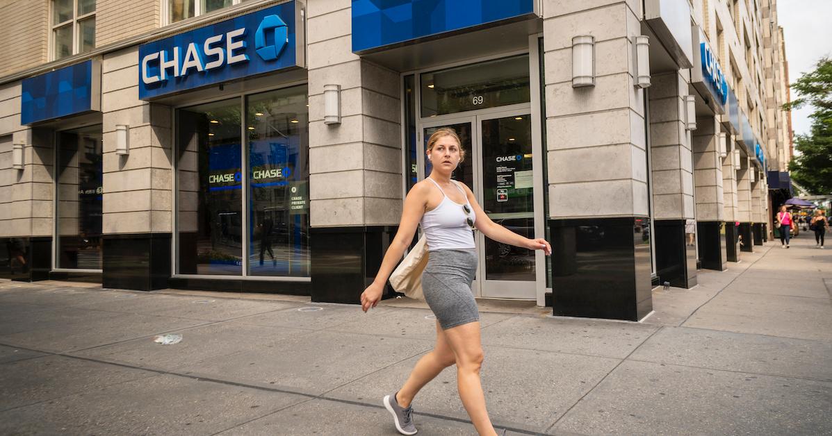 woman walking past Chase Bank branch in NYC