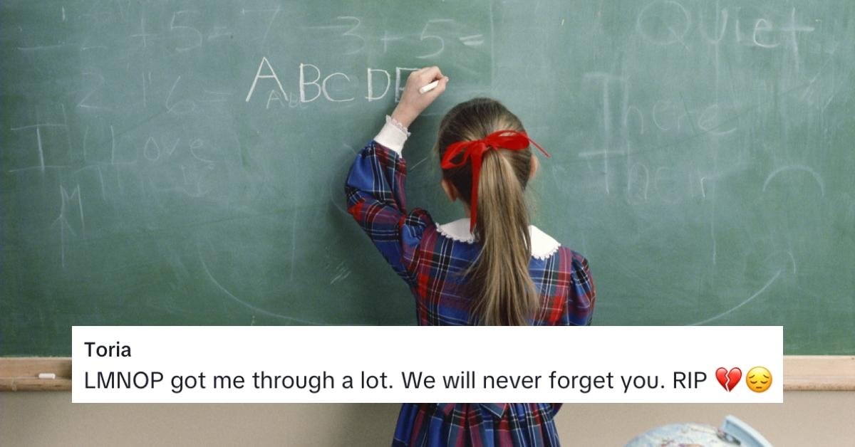 A girl writing her ABCs on a chalk board.