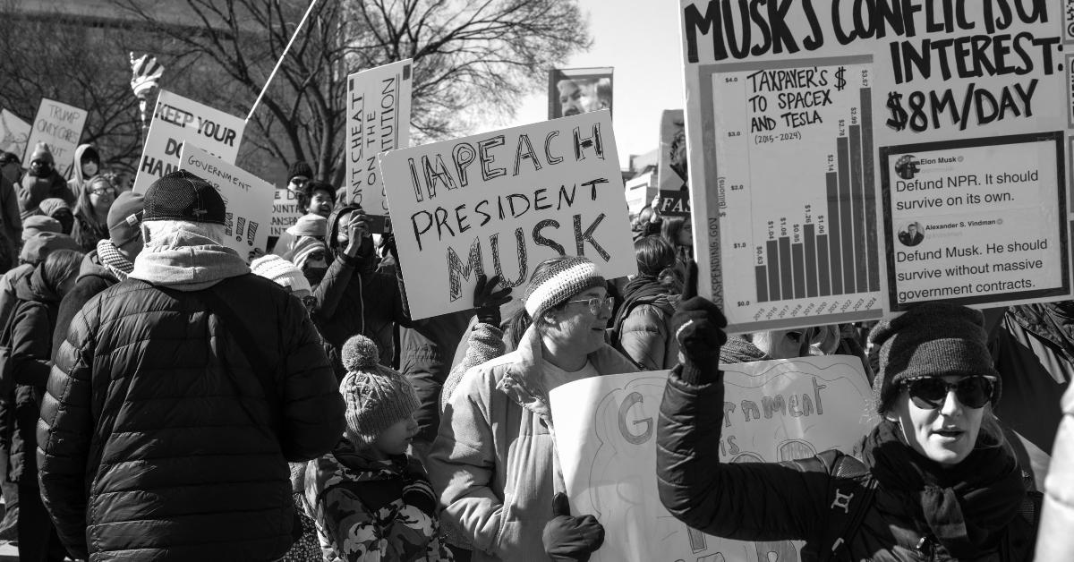 Protest sign reads "Impeach President Musk" 