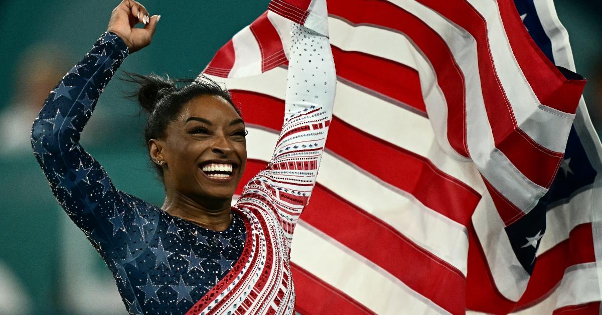 US' Simone Biles celebrates after team USA won the artistic gymnastics women's team final during the Paris 2024 Olympic Games at the Bercy Arena in Paris, on July 30, 2024. (Photo by Loic VENANCE / AFP) (Photo by LOIC VENANCE/AFP via Getty Images)