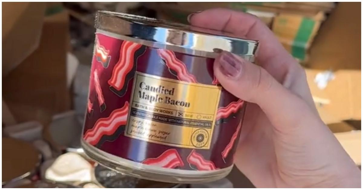 A woman holding a Bath and Body Works candle