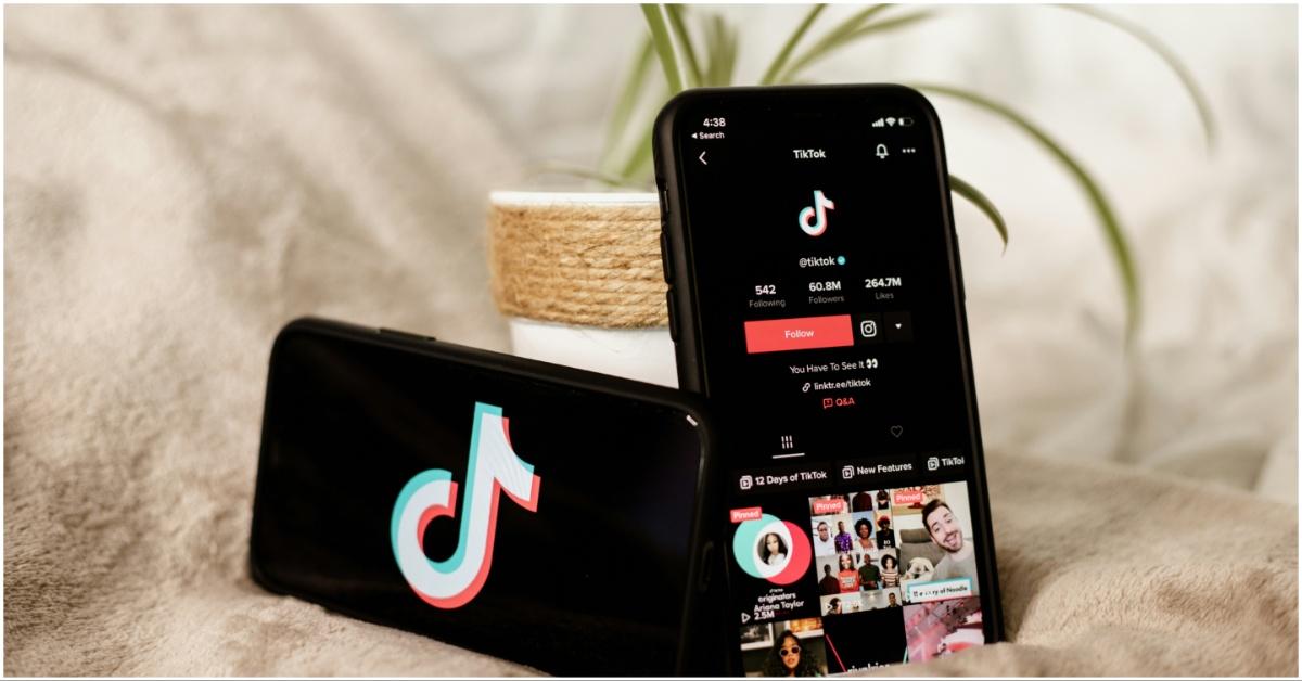 Two iPhones with TikTok being featured on them on a blanket
