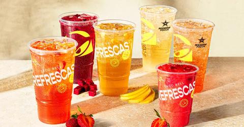 Taco Bell Refrescas with fruit near them.