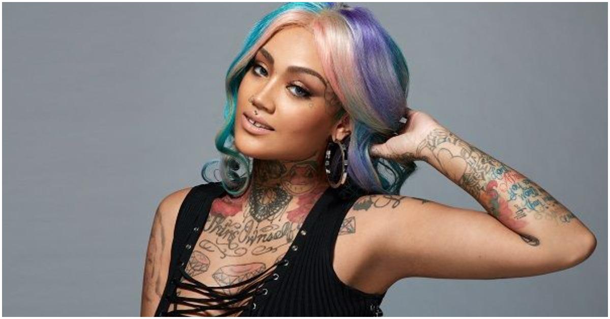 Donna from 'Black Ink Crew' holding her head in a promotional picture.