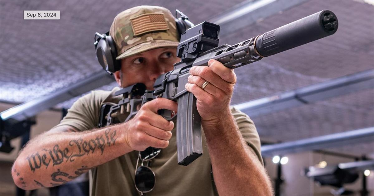 Pete Hegseth firing a machine gun in a t-shirt. 