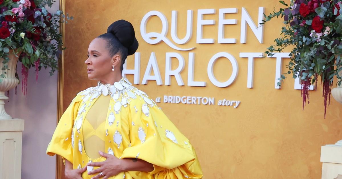 Golda Rosheuvel in a yellow and white dress, poses at the 'Queen Charlotte: A Bridgerton Story' LA premiere 