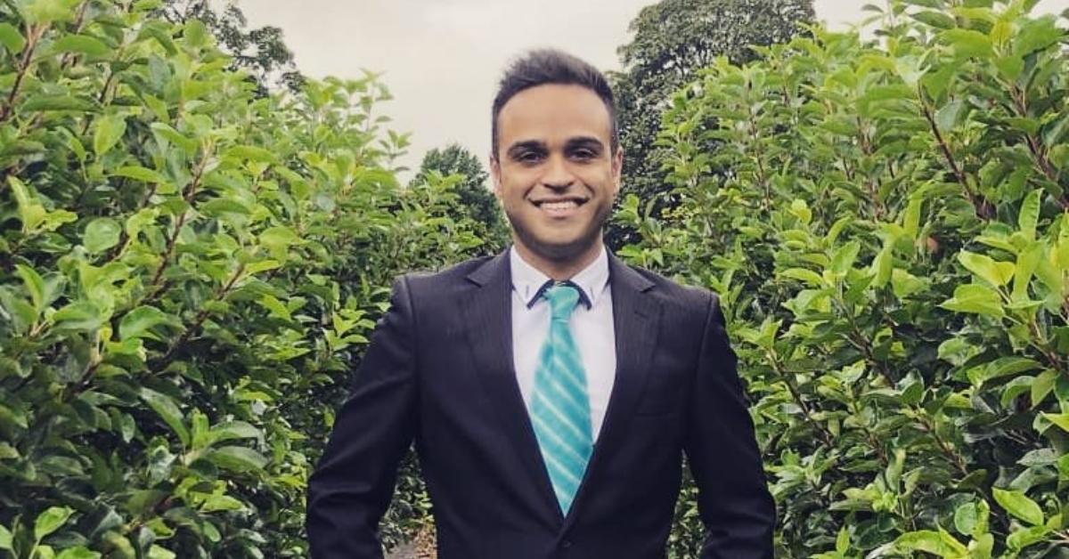 Kunal Dhawan posing in a vinyard wearing a suit.