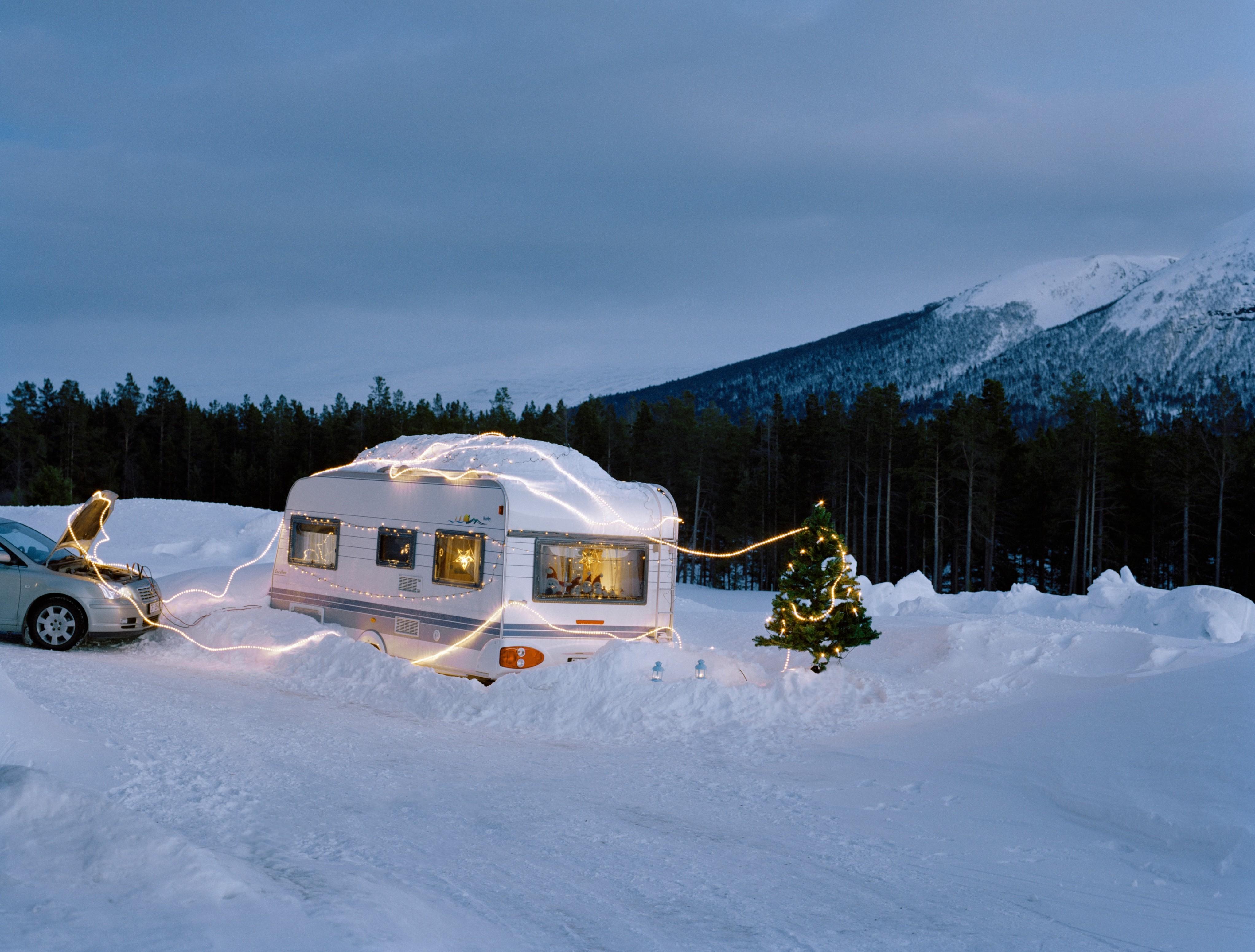 Car powering Christmas lights on caravan.