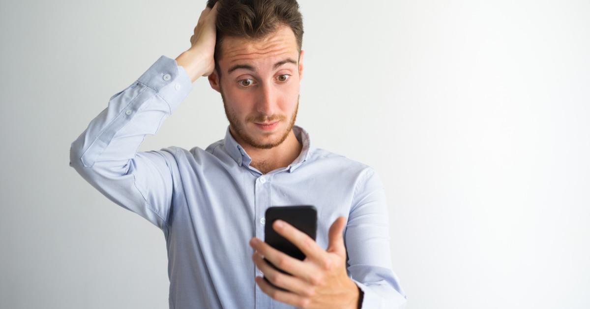 confused businessman reading message on phone picture id