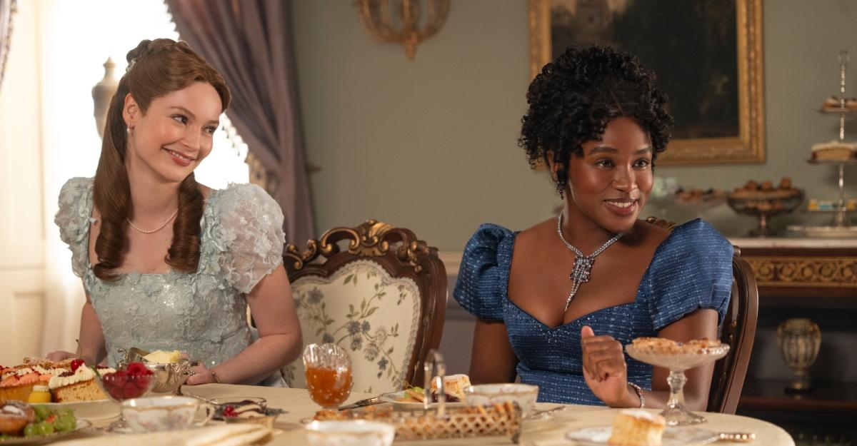 Francesca looks over at Michaela as they sit next to each other at tea.