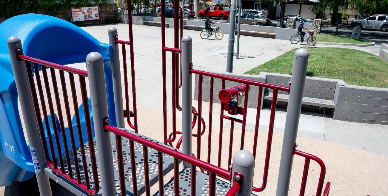 A playground and kids riding bikes