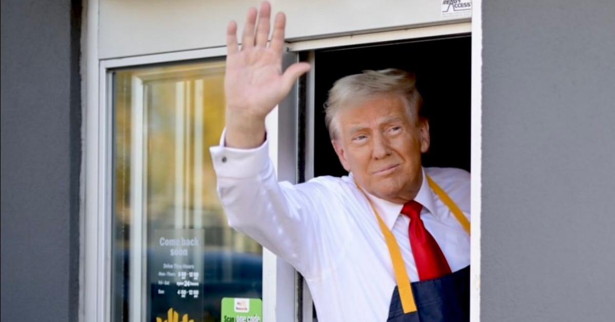 Donald Trump waves out of a McDonald's drive-thru window