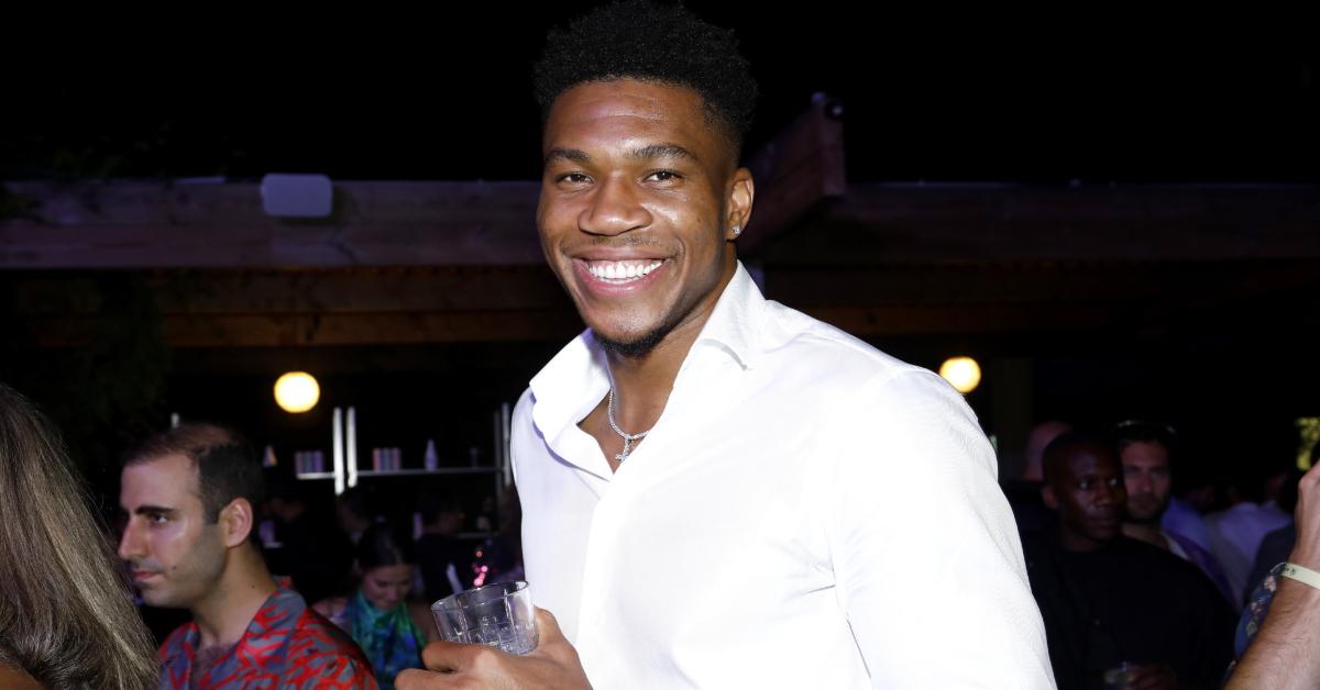 Giannis Antetokounmpo wearing a white dress shirt