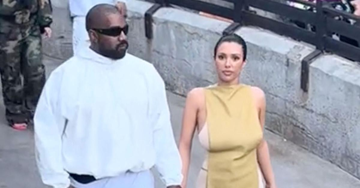 Ye, aka Kanye West, and Bianca Censori walking around Disneyland in April 2024.