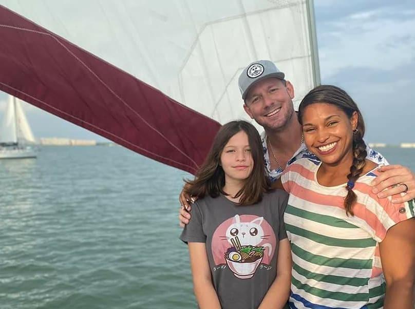 Brian and Mika with their daughter Jade on a boat