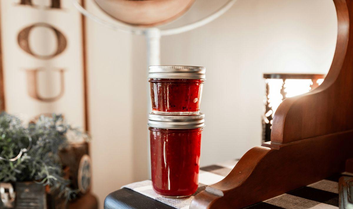 Two jars of jam sitting on a table