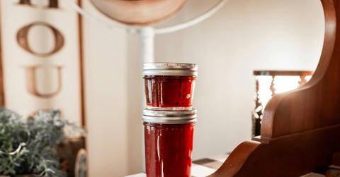 Two jars of jam sitting on a table
