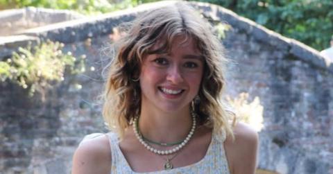 Kate Shemirani's daughter Paloma standing by water.