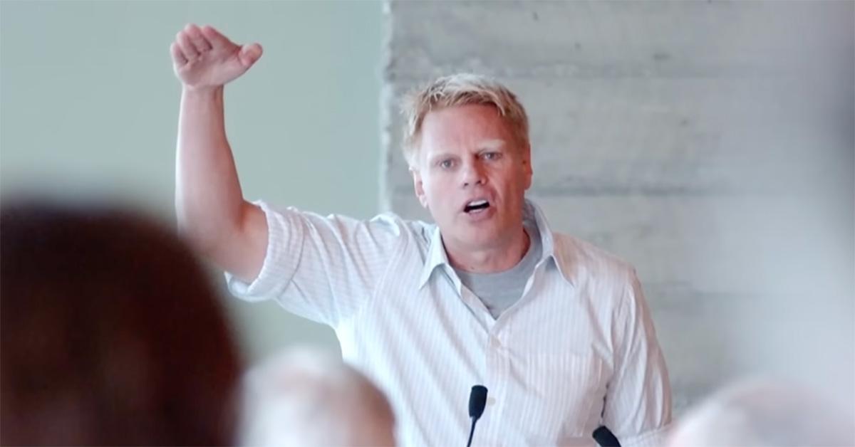 Mike Jeffries speaking at a lectern. 