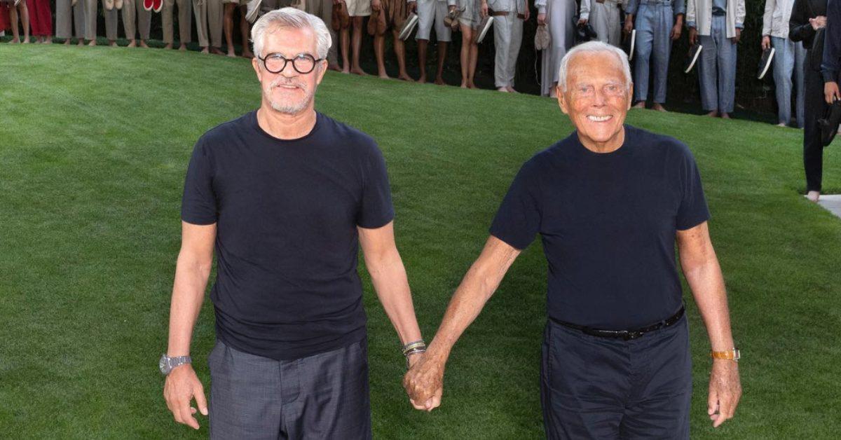 Giorgio Armani and Leo Dell'Orco holding hands.