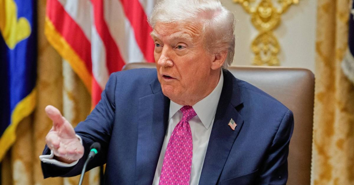 Donald Trump calling attention to something with his hand