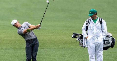 A golfer and caddie at the Masters
