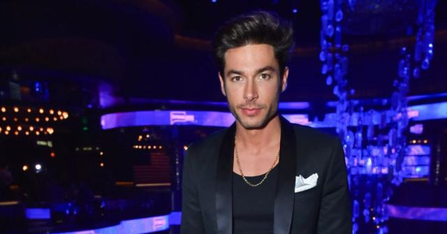 Andrea Denver wearing a black suit