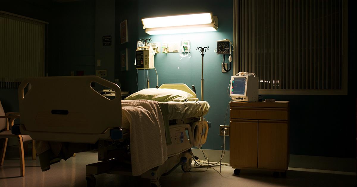 An empty hospital bed at night. 