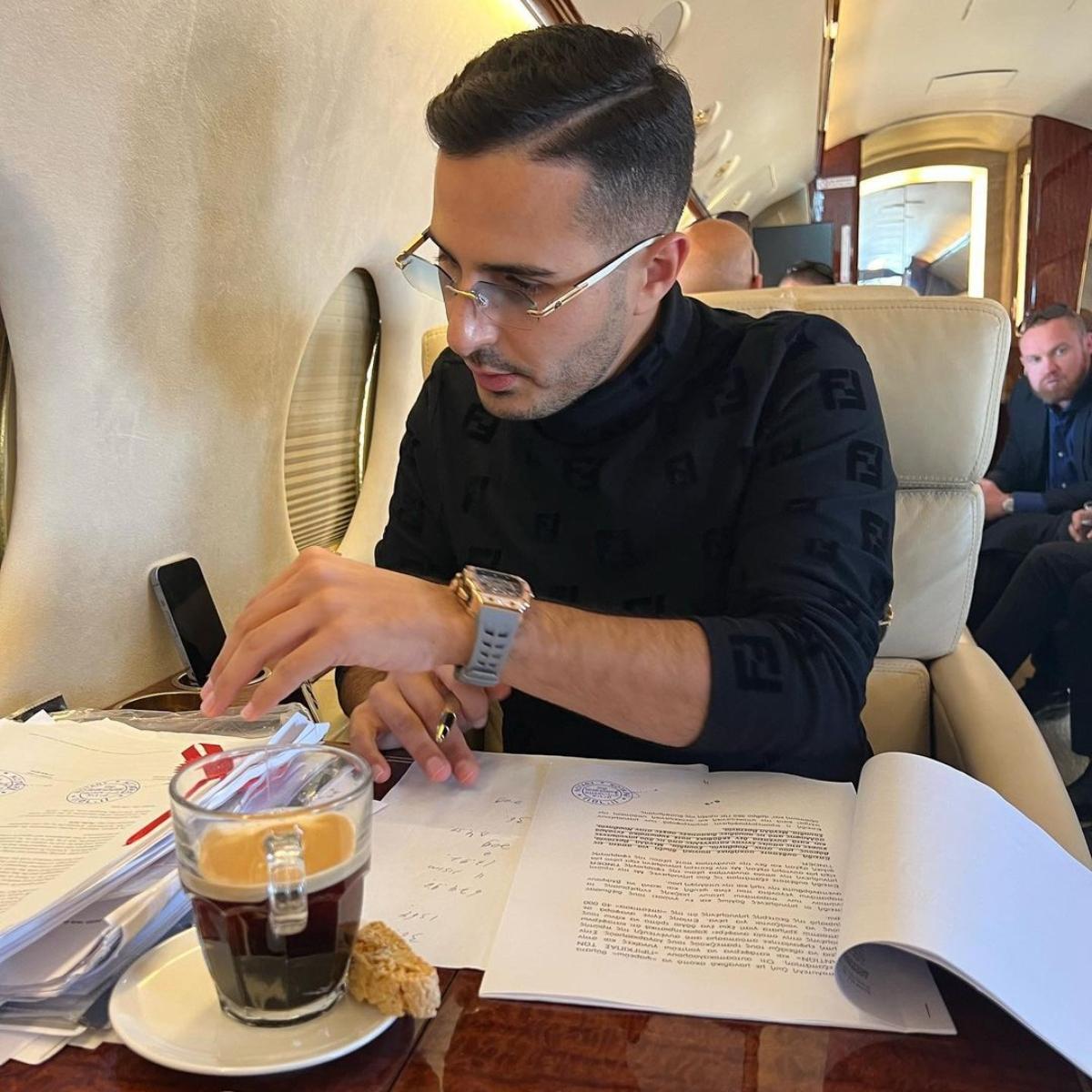 "Tinder Swindler" Simon Leviev wears a black turtleneck and glasses, looks busy with work on a private jet.