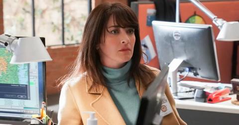 Delilah sitting at her desk at work on 'NCIS'.