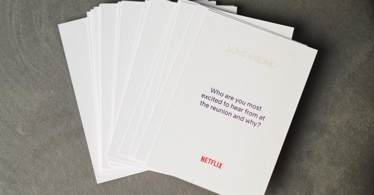 A white card at the VIP Watch Party and Celebration for 'Love Is Blind: The Live Reunion' reads, "Who are you most excited to hear from at the reunion and why?"