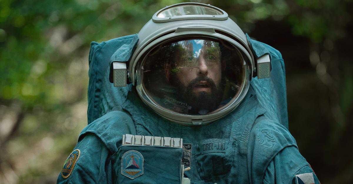 Adam Sandler as Jakub in 'Spaceman' wearing a spacesuit on Earth.