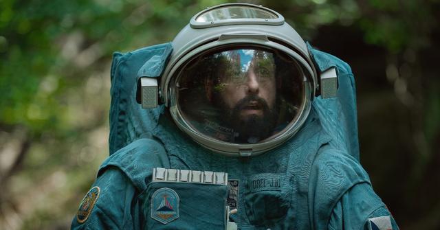 Adam Sandler as Jakub in 'Spaceman' wearing a spacesuit on Earth.